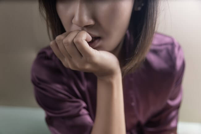 Person struggling with anxiety and addiction.